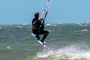 Kite board enthusiast flying out of the water at the Canadian Hole.